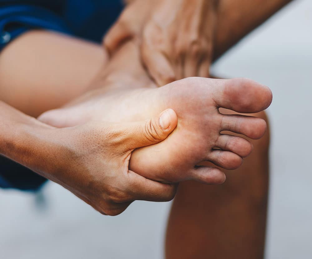 Holding foot with Peripheral Neuropathy