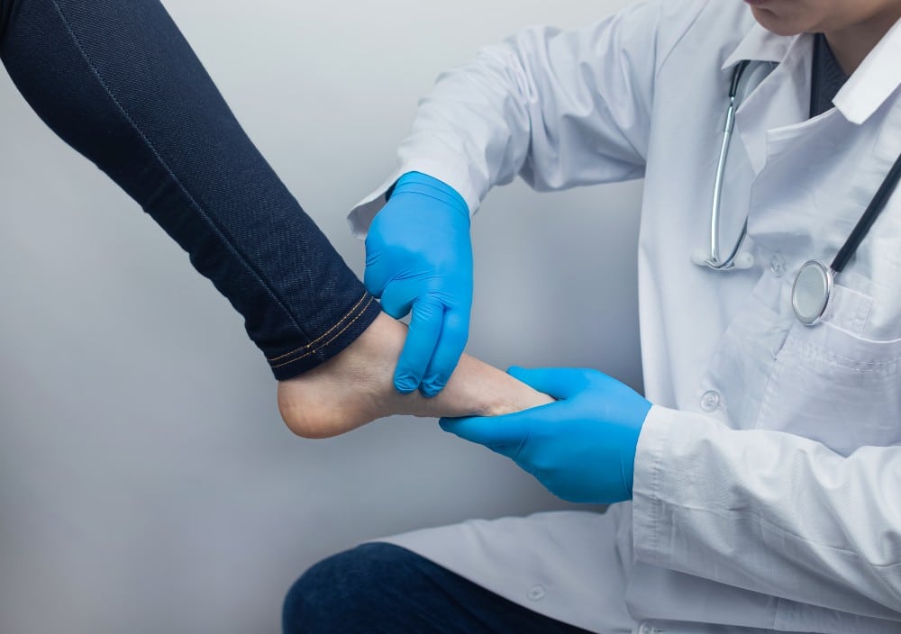 Podiatrist evaluating woman's foot for plantar fasciitis