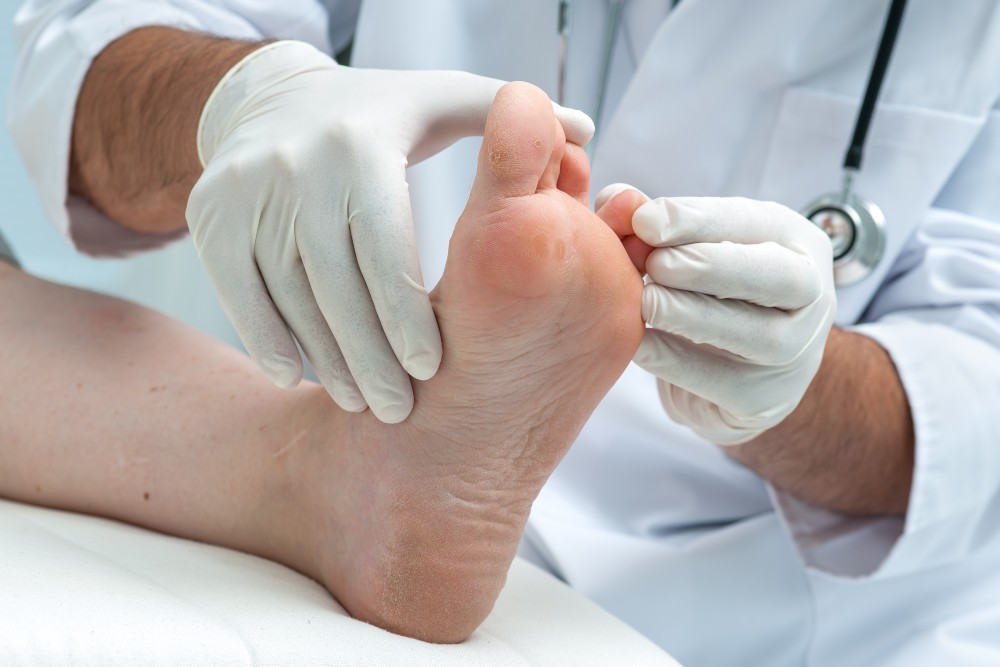 Doctor examining foot with hammertoes